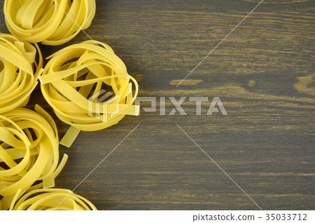 Tagliatelle on wooden background 35033712