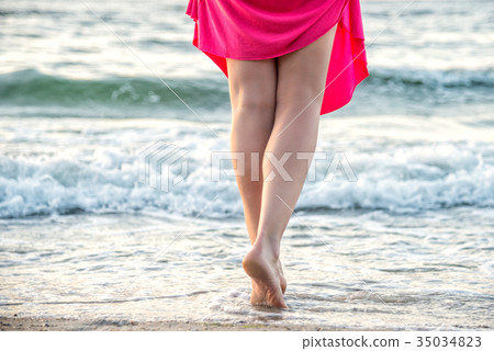 Beach travel - woman walking Beach travel - woman walking 35034823