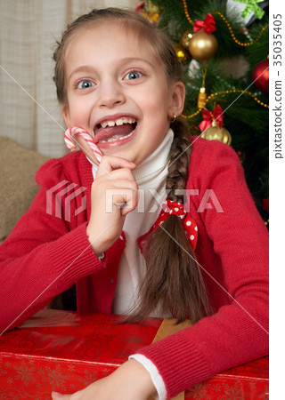 Unhappy girl crying near christmas tree Unhappy girl crying near christmas tree 35035405