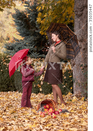 woman and girl with umbrella in autumn forest woman and girl with umbrella in autumn forest 35035447