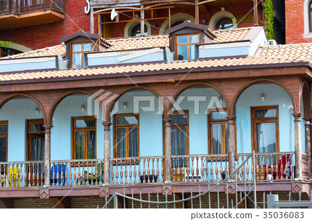 Houses with traditional wooden carving balconies 35036083