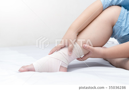 child touch ankle with elastic bandage,broken leg child touch ankle with elastic bandage,broken leg 35036286