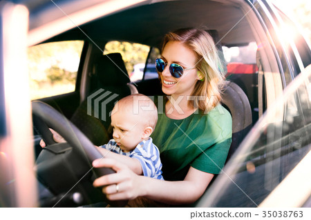 Young mother with her little baby boy in the car. 35038763