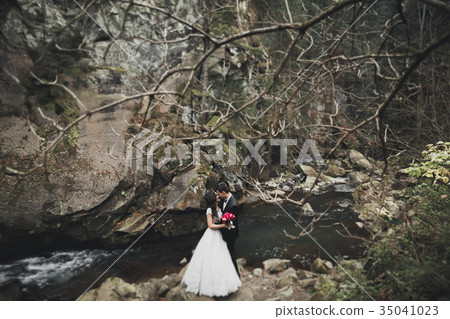 Wedding couple in love kissing and hugging near 35041023