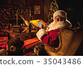 Santa Claus looks at camera while using smartphone 35043486