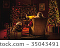 Santa Claus sitting in workshop, wide shot 35043491