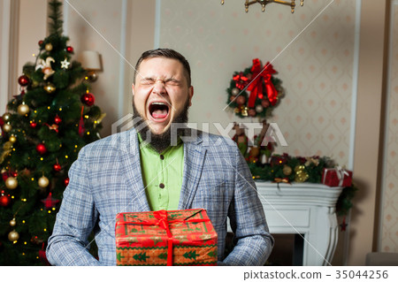man with beard yawning and holding a box man with beard yawning and holding a box 35044256