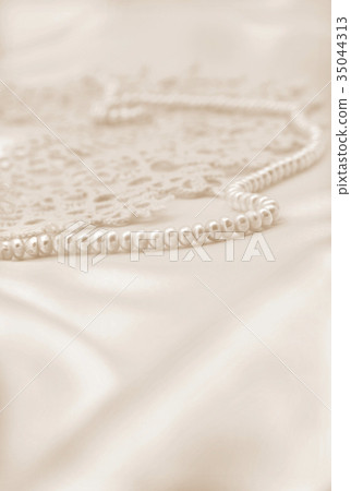 Smooth elegant golden silk or satin with pearls Smooth elegant golden silk or satin with pearls 35044313