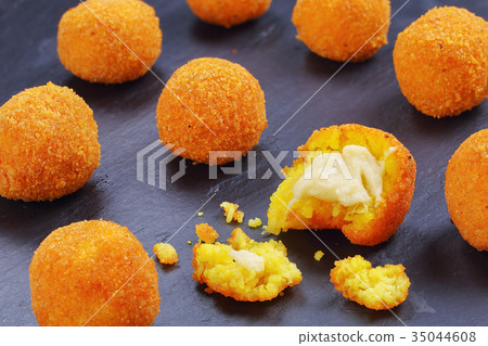 arancini - saffron rice balls stuffed with cheese arancini - saffron rice balls stuffed with cheese 35044608