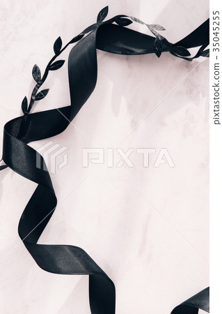 Black ribbon on white marble background Black ribbon on white marble background 35045255