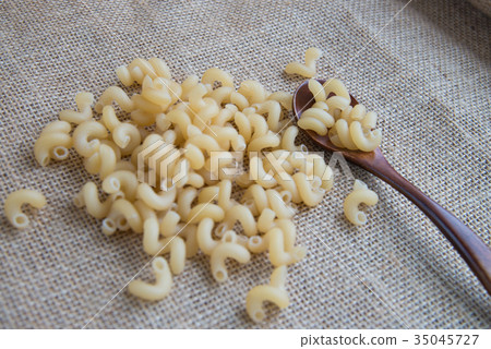Cavatappi raw pasta on rustic background . Natural Cavatappi raw pasta on rustic background . Natural 35045727
