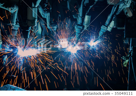 Team robots are welding automotive part. 35049111