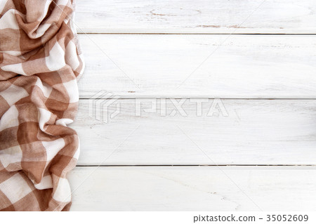 The Crumpled brown checkered tablecloth or napkin The Crumpled brown checkered tablecloth or napkin 35052609
