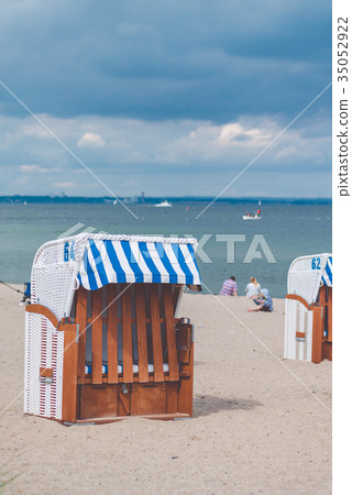 Blue striped roofed chairs on empty sandy beach in Blue striped roofed chairs on empty sandy beach in 35052922