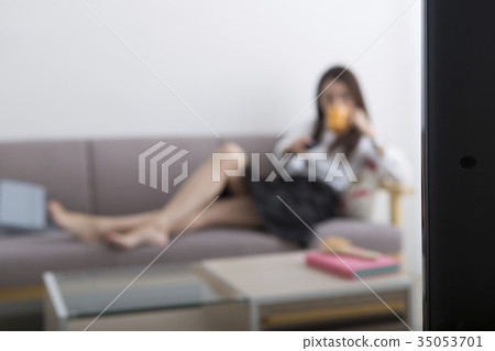 A woman watching TV A woman watching TV 35053701