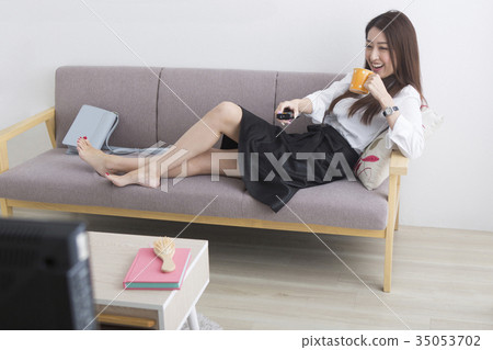 A woman watching TV A woman watching TV 35053702