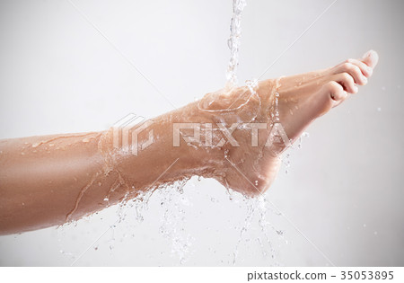 Beautiful female leg under clean water stream. 35053895