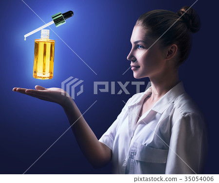Young cosmetologist woman presents cosmetics oil 35054006