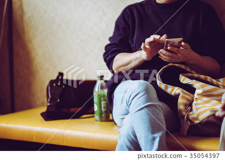 A woman operating a smartphone A woman operating a smartphone 35054397