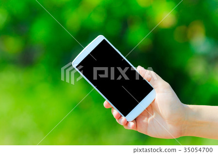 Smartphone and green background Smartphone and green background 35054700