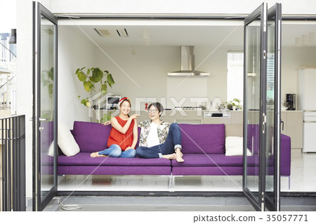 A couple relaxing in the living room 35057771