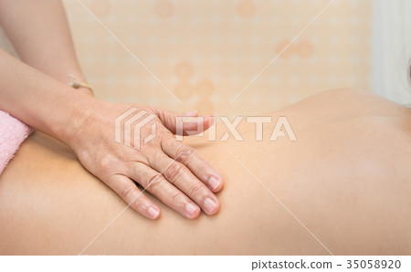 Spa hand on woman back for Massage Spa Skin care Spa hand on woman back for Massage Spa Skin care 35058920