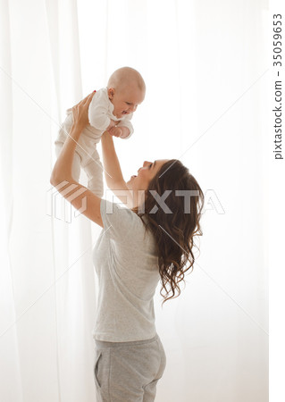 Woman playing with infant child 35059653