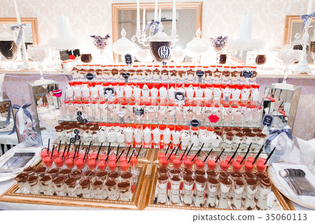 Delicious and tasty dessert table with cupcakes 35060113