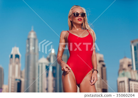 Sexy blonde woman in a red bathing suit is Sexy blonde woman in a red bathing suit is 35060204