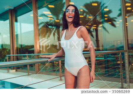 Sexy woman in white swimsuit posing outdoors. Mock Sexy woman in white swimsuit posing outdoors. Mock 35060269