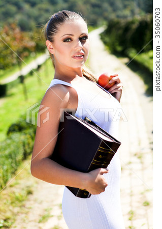 Beauty woman with book and red apple Beauty woman with book and red apple 35060703