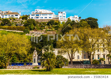 houses on a cliff hill, on rock among green plants 35063414