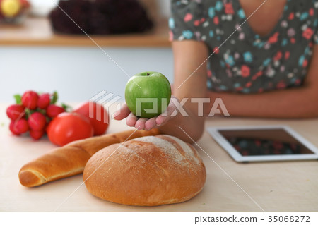 Close-up of female hand holding green apple in Close-up of female hand holding green apple in 35068272