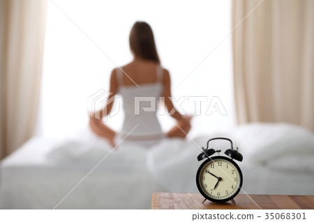 Alarm clock standing on bedside table has already Alarm clock standing on bedside table has already 35068301
