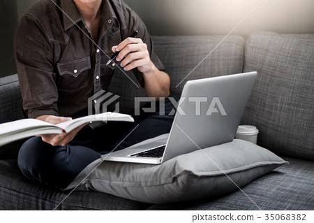 Handsome Young Man Sitting on the Living Room Couch, Casual youn 35068382