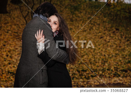 couple hugs in a fall park. Golden Autumn on the couple hugs in a fall park. Golden Autumn on the 35068827