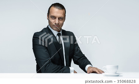 The attractive man in black suit on white The attractive man in black suit on white 35068828