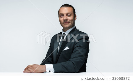 The attractive man in black suit on white The attractive man in black suit on white 35068872