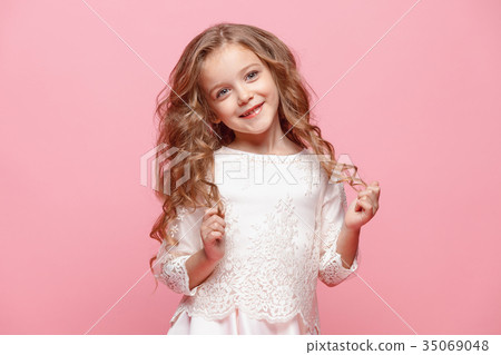 The beautiful little girl in dress standing and The beautiful little girl in dress standing and 35069048