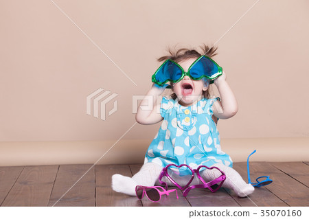 little girl plays with big glasses, she funny 35070160