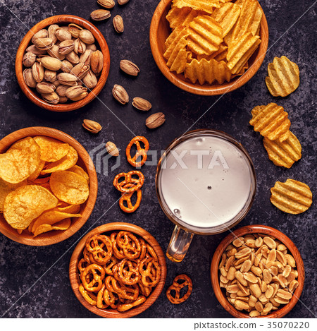 Beer with snacks on stone background. Beer with snacks on stone background. 35070220