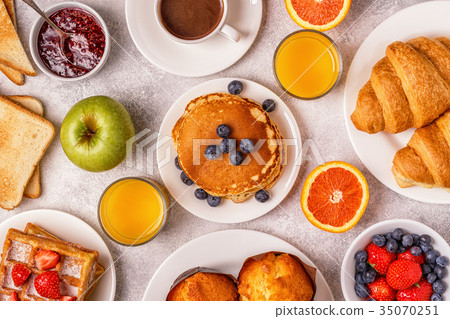 Delicious breakfast on a light table. Delicious breakfast on a light table. 35070251