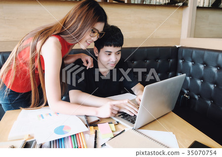 Young woman and man studying for a test or an exam. 35070754