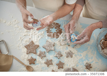 Skillful arms sculpting cookies before baking Skillful arms sculpting cookies before baking 35071306