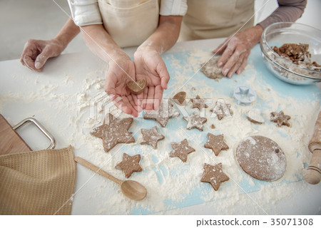 Girl presenting self-made shape of dough in hands Girl presenting self-made shape of dough in hands 35071308