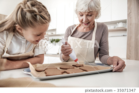 Happy grandmother squeezing cream on holiday 35071347