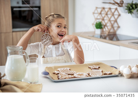 Happy female kid having fun with holiday sweet Happy female kid having fun with holiday sweet 35071435