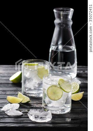 Selective focus composition with gin and tonic 35072451