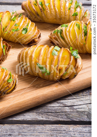 Freshly baked hasselback potatoes Freshly baked hasselback potatoes 35073172