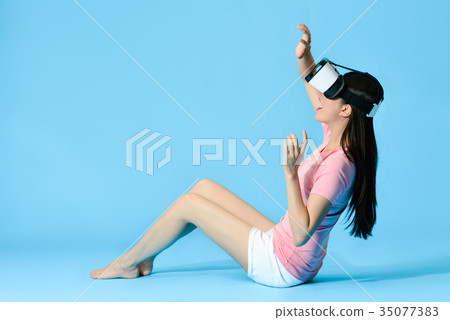 beautiful girl sitting on blue background floor beautiful girl sitting on blue background floor 35077383